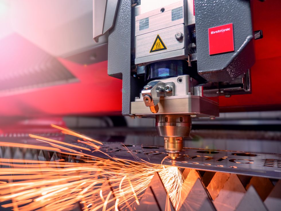 Advanced laser cutting machine performing intricate laser cutting on metal.