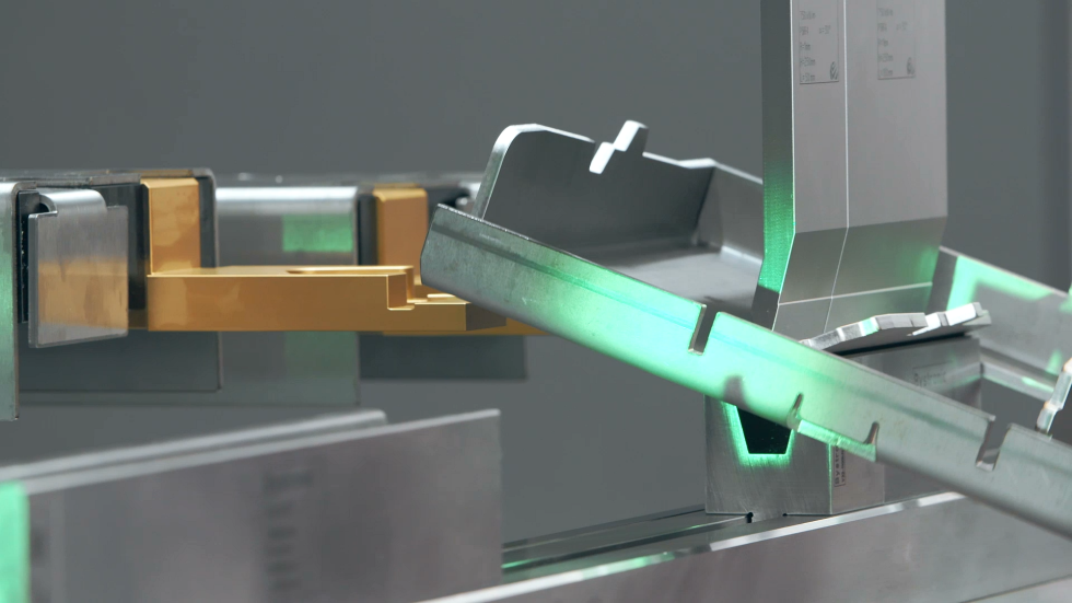 Image of a hydraulic bending machine in action, bending metal with a heavy-duty sheet metal bender.