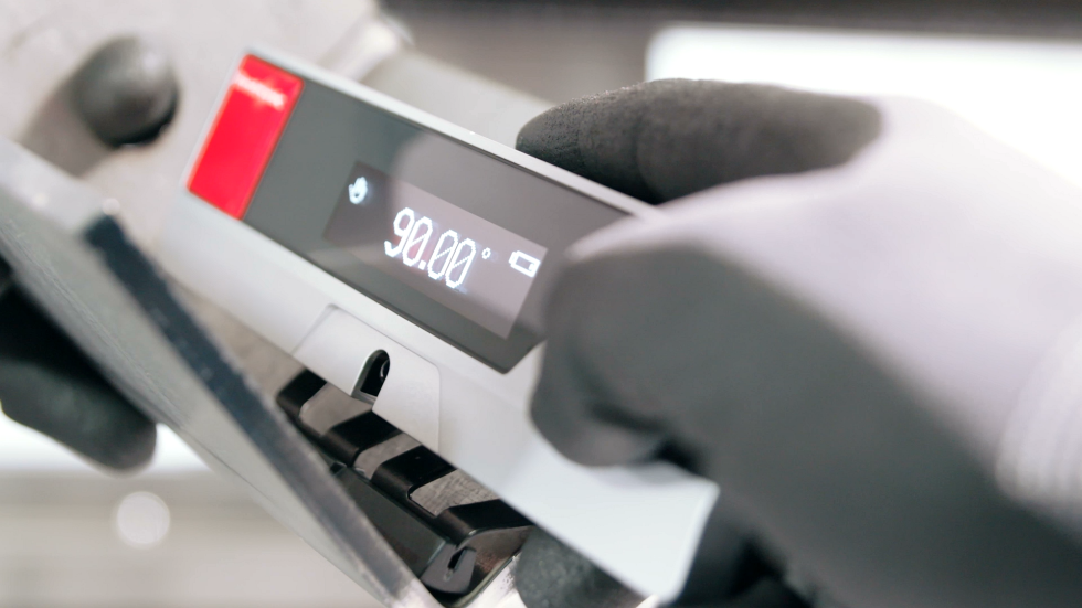 Industrial workshop featuring a hydraulic bending machine expertly bending metal sheets, highlighting the strength and efficiency of a heavy-duty sheet metal bender in action.